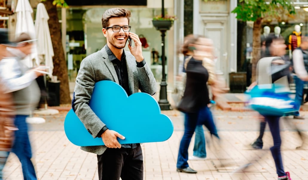 Young businessman with big blue cloud