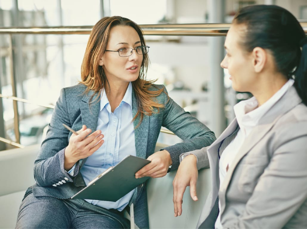 Marketing and sales professionals having a conversation.