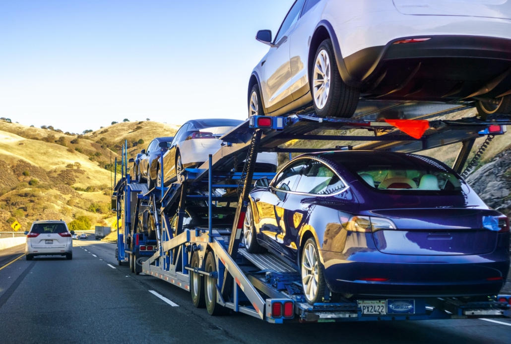 Automotive transport trailer carrying multiple vehicles.