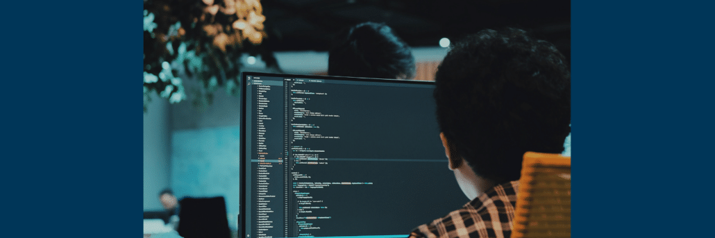 view from behind a person working on a computer monitor