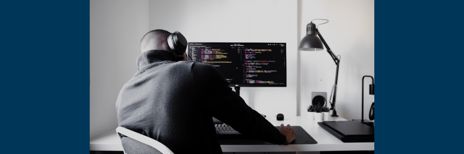 Man in headphones on a computer running real-time searches