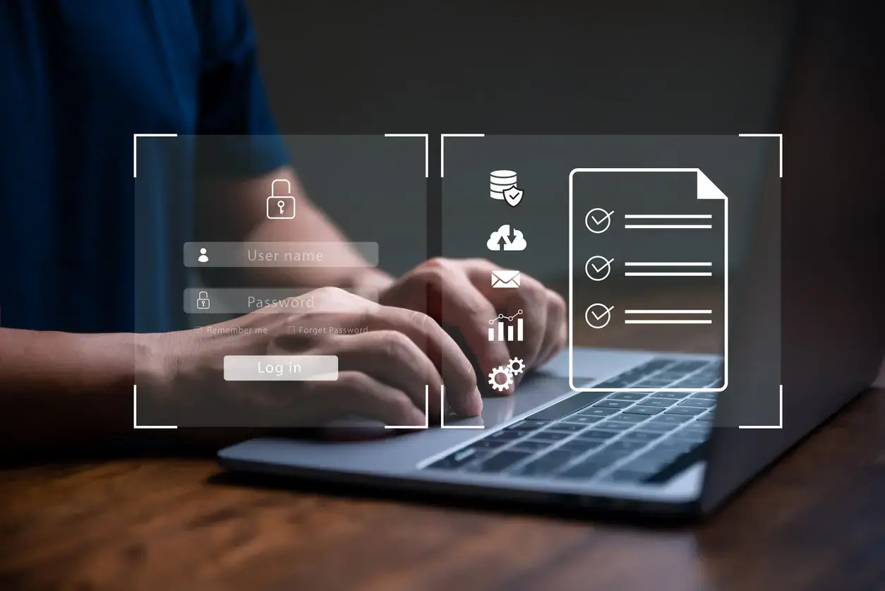 Hands typing on a laptop with overlaid icons of security and performance metrics.