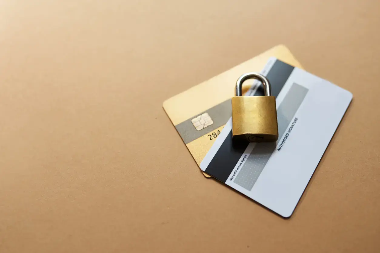 Credit cards with a lock on top of them, representing proactive fraud prevention for banking.