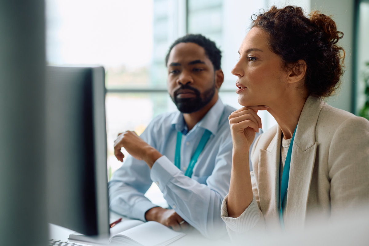 Cybersecurity advisory team analyzing risk data to support vCISO-led security strategy.