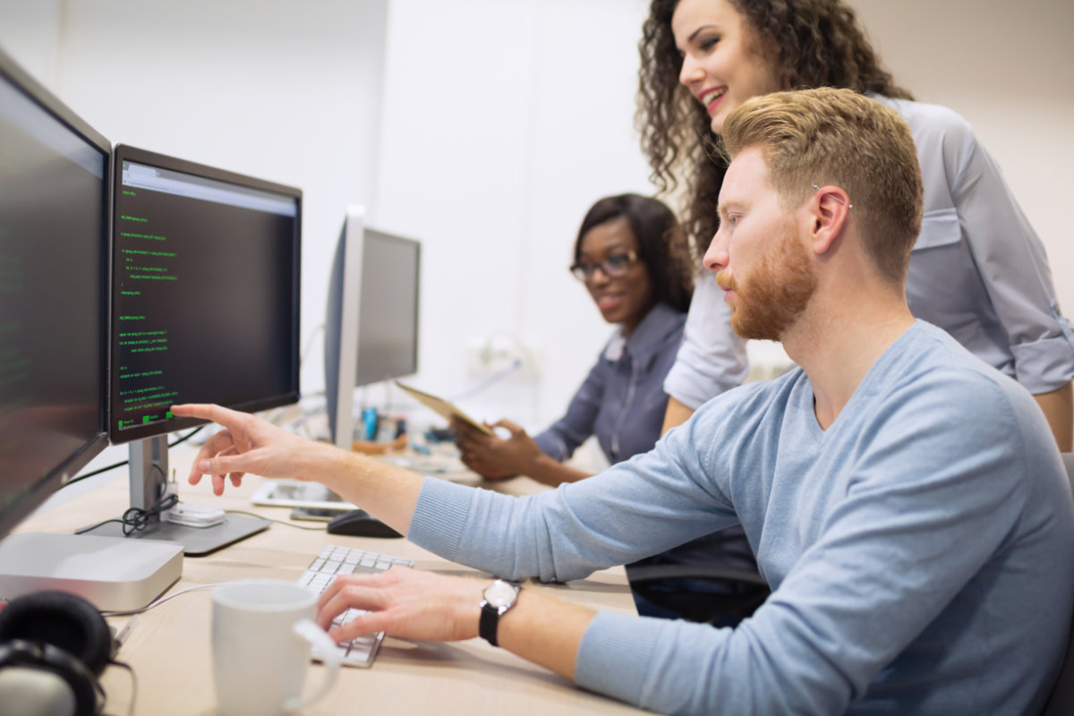 Team members collaborating at a workstation.