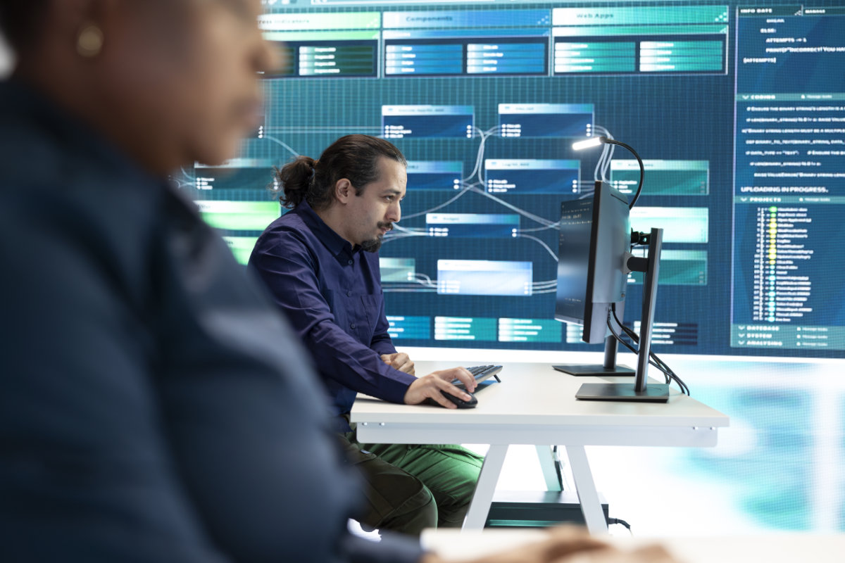 Cybersecurity specialist reviewing system architecture for risk assessment and security governance.